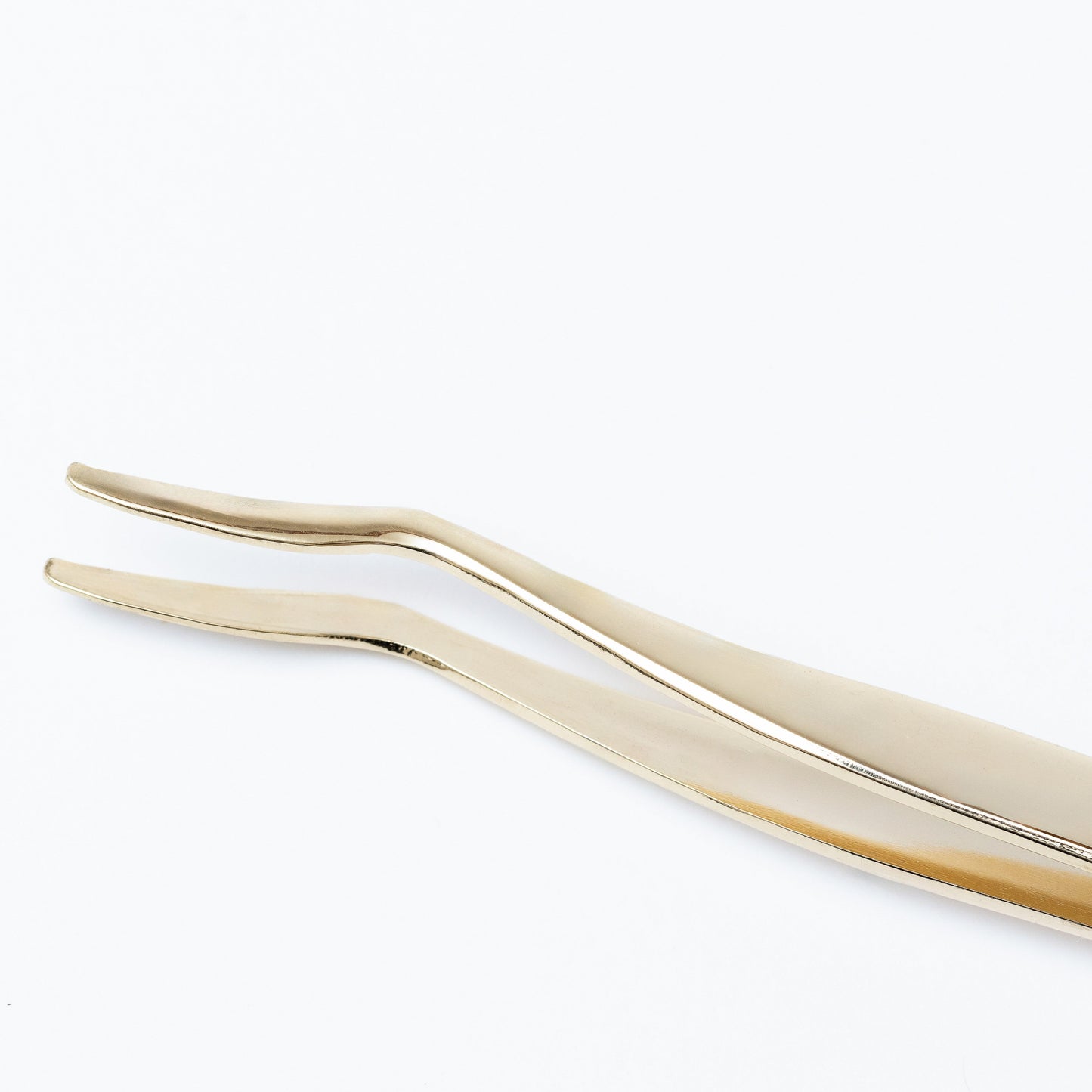 Gold metal lash applicator designed for precise application of lash extensions and strip lashes.