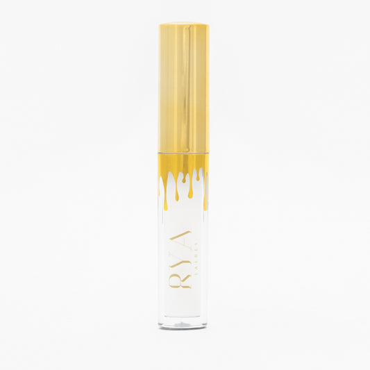 Clear lash glue in a sleek container with a gold cap, designed for a flawless, long-lasting hold on strip lashes.
